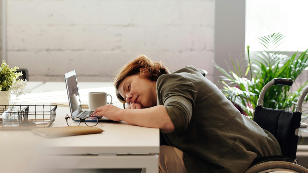 a woman fell asleep on a laptop